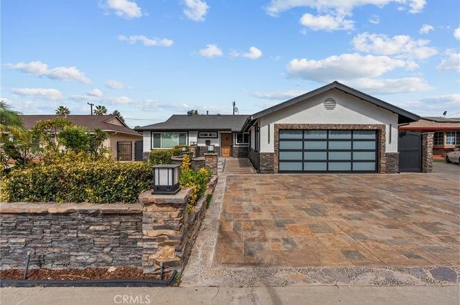 home in California with stone-accented facade and large garage door.